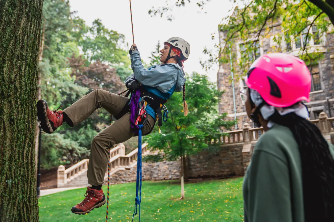Michelle Elise Spicer ’12 ’14G climbing trees on the Asa Packer campus as she trains her student mentees in tree-climbing safety.
